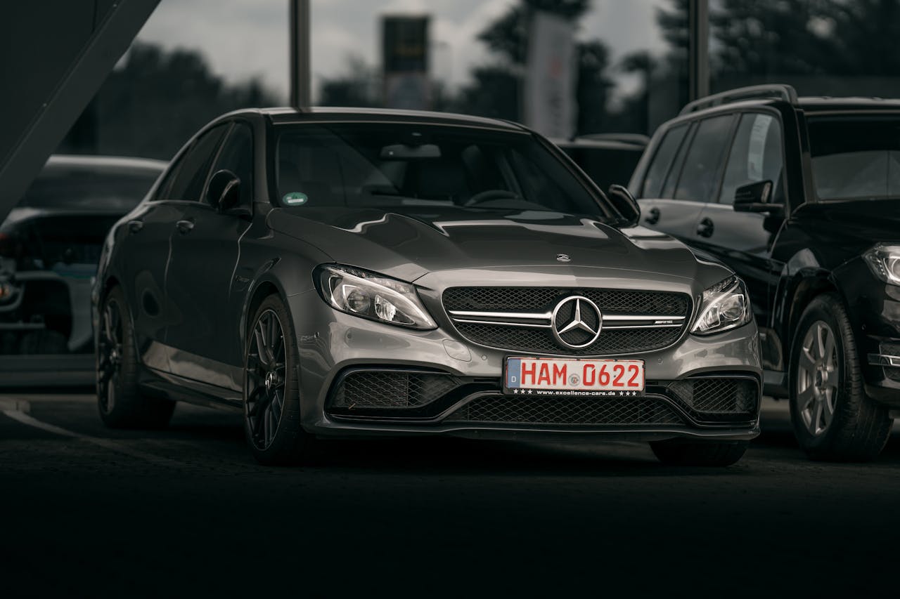 Elegant silver luxury car parked in a city setting, showcasing sleek design and modern style.